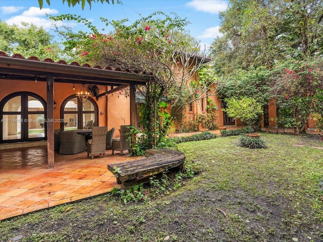 view of yard with a patio and french doors