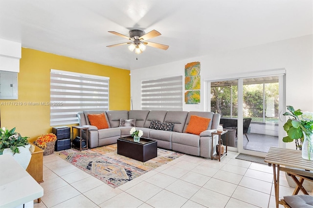 tiled living room with ceiling fan and electric panel