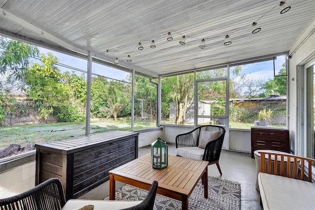 sunroom featuring plenty of natural light and wooden ceiling