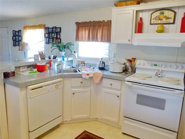 kitchen featuring sink, white appliances, white cabinetry, and range hood