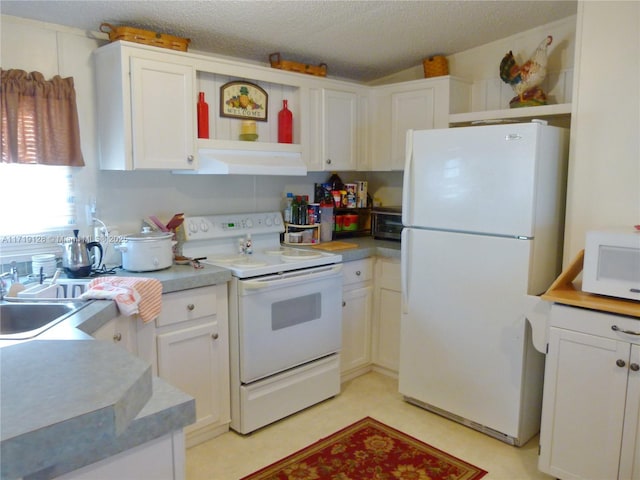 kitchen with a textured ceiling, white cabinetry, sink, and white appliances