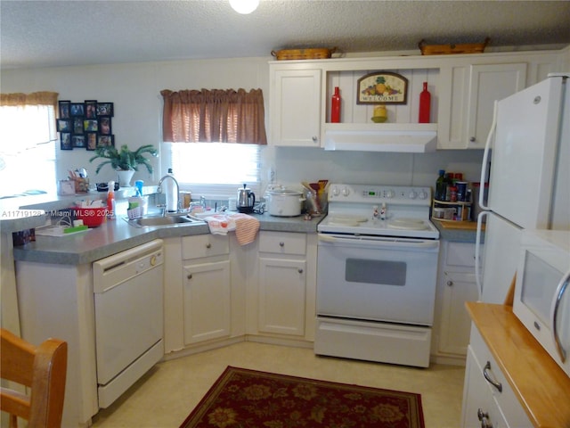 kitchen with a healthy amount of sunlight, white cabinetry, white appliances, and sink