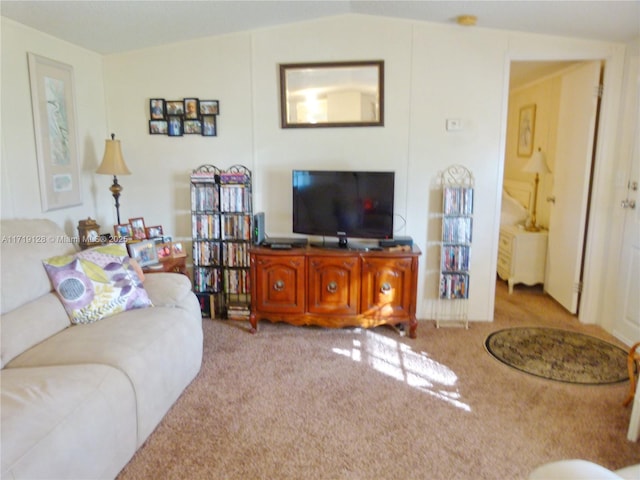 carpeted living room featuring vaulted ceiling