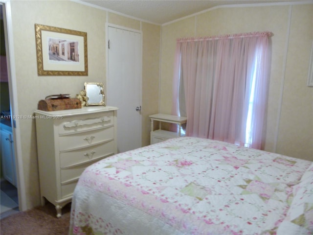 bedroom featuring vaulted ceiling and crown molding