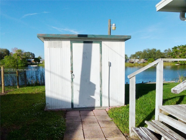 view of outbuilding featuring a yard and a water view