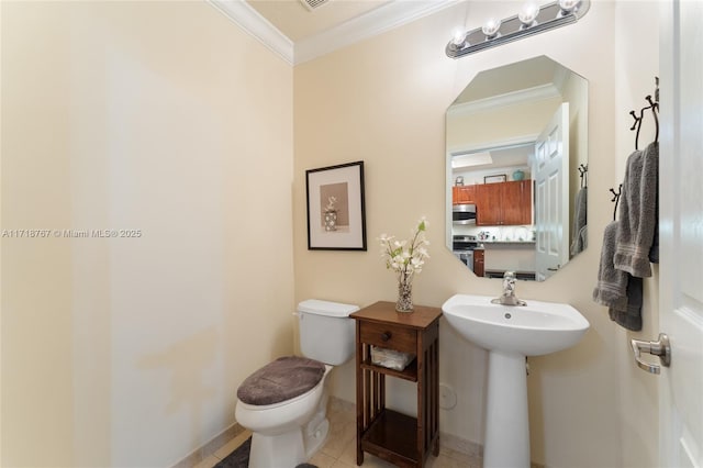 bathroom featuring tile patterned flooring, toilet, and ornamental molding