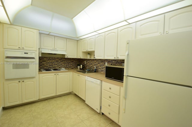 kitchen with white cabinetry, sink, white appliances, and decorative backsplash