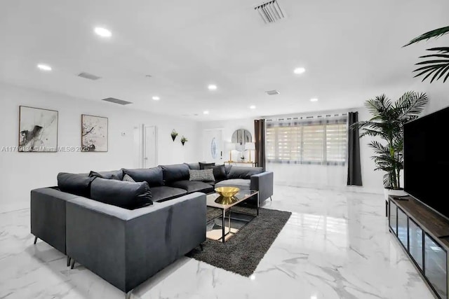 living area with recessed lighting, marble finish floor, and visible vents