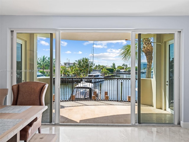 entryway featuring a water view and a healthy amount of sunlight