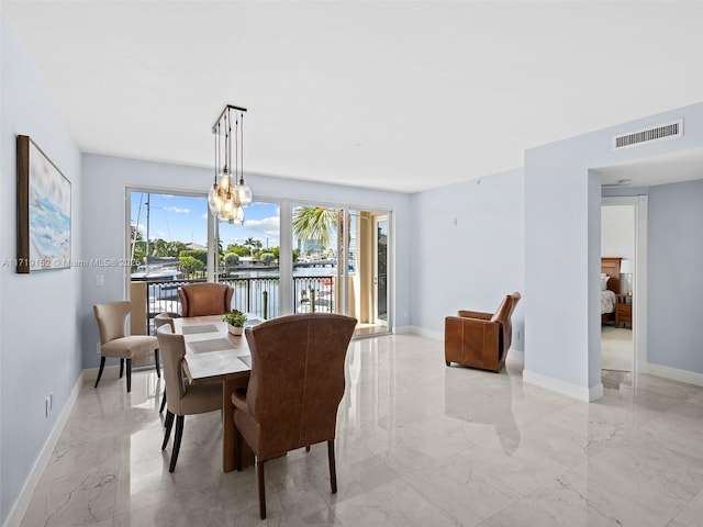 dining room featuring a water view