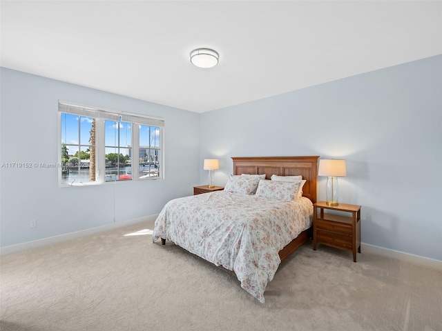 bedroom featuring light colored carpet