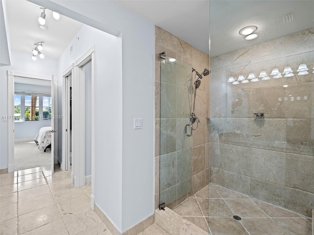 bathroom featuring a shower with shower door