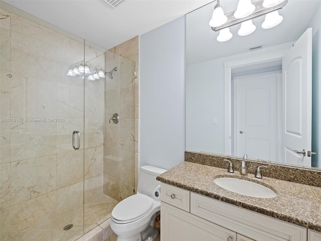 bathroom with vanity, an enclosed shower, and toilet