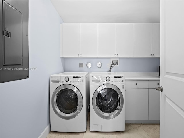 clothes washing area featuring cabinets, electric panel, and separate washer and dryer