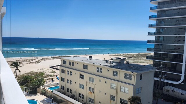 view of property with a beach view and a water view