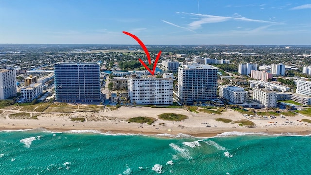 aerial view with a water view and a beach view