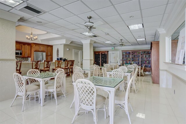 kitchen featuring stainless steel appliances, a kitchen breakfast bar, a notable chandelier, decorative light fixtures, and decorative backsplash