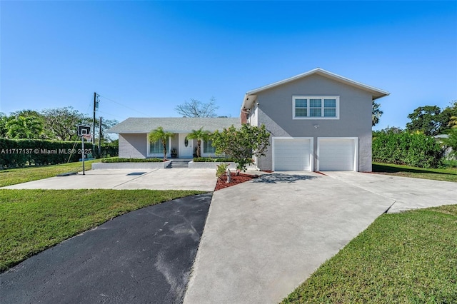 view of front of home with a front yard and a garage