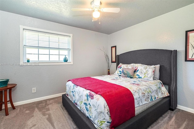 carpeted bedroom with a textured ceiling and ceiling fan