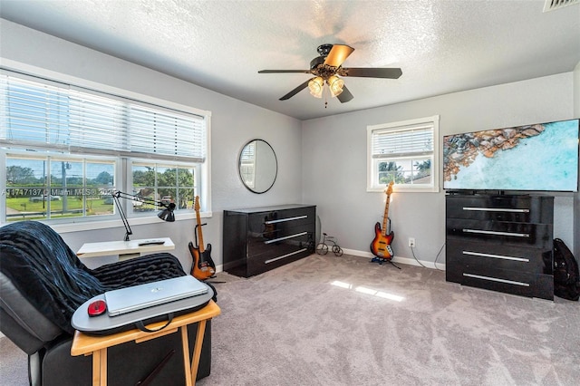 miscellaneous room featuring ceiling fan, a textured ceiling, and light carpet