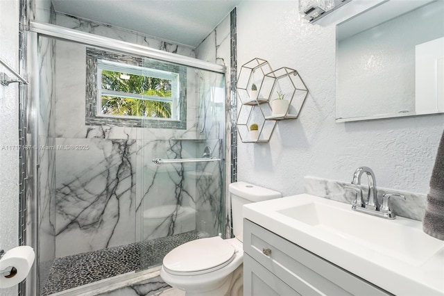 bathroom featuring vanity, toilet, and a shower with door