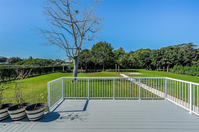 wooden deck with a lawn