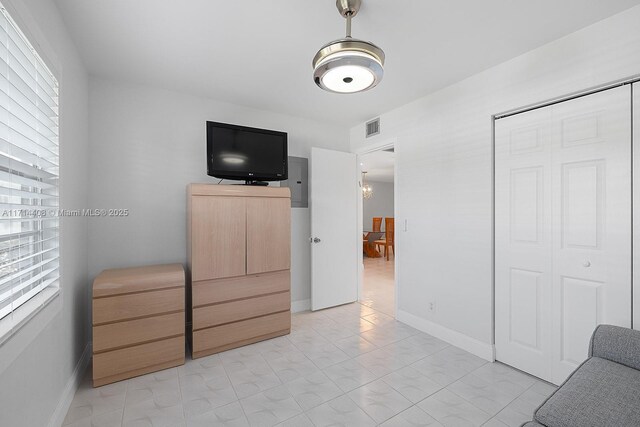 bedroom with multiple windows and a closet