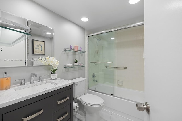 full bathroom featuring vanity, toilet, and combined bath / shower with glass door