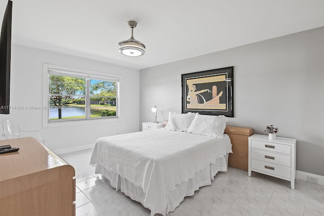 bedroom featuring a water view