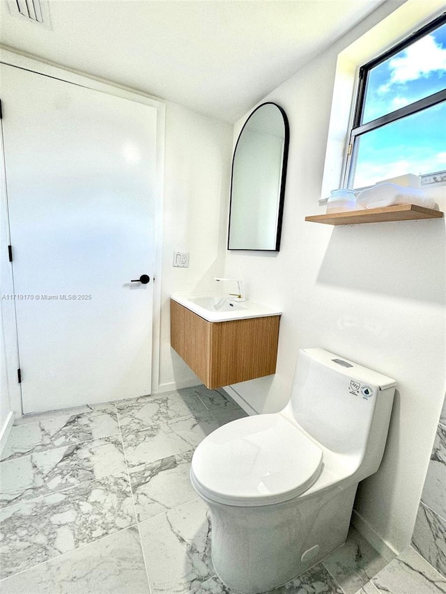 bathroom with vanity and toilet