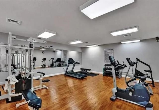 workout area with hardwood / wood-style flooring