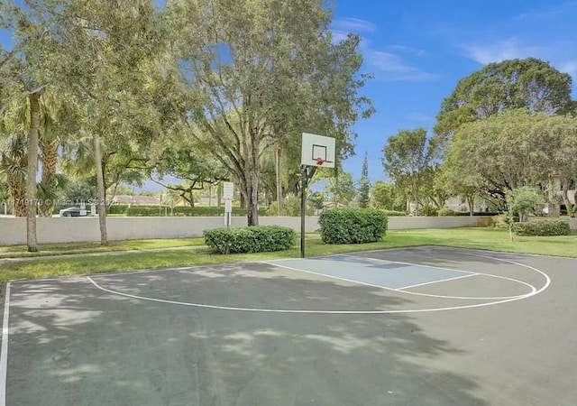 view of basketball court with a yard