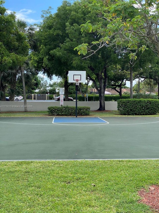 view of sport court featuring a lawn