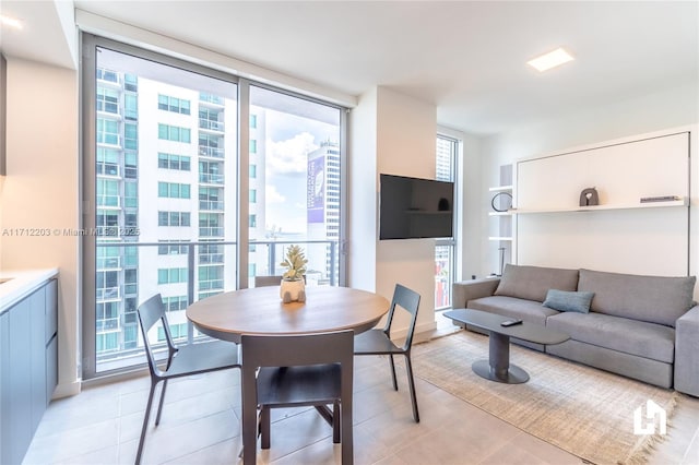 dining space featuring floor to ceiling windows