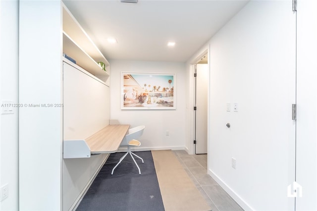 unfurnished office with light tile patterned floors