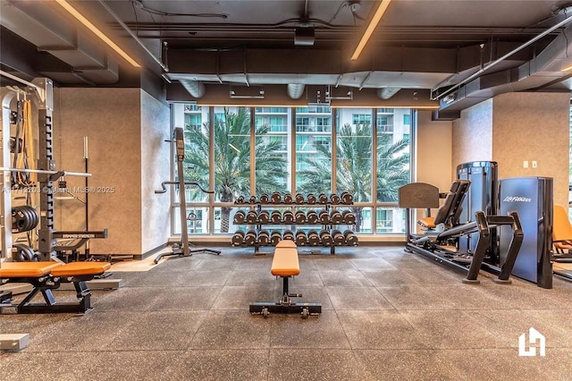 exercise room with floor to ceiling windows and plenty of natural light