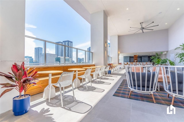 view of patio / terrace with ceiling fan and a balcony