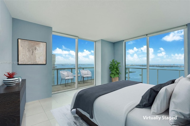 bedroom with floor to ceiling windows, light tile patterned flooring, and a water view