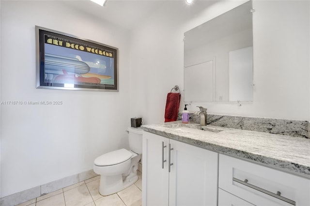 bathroom with toilet, tile patterned floors, and vanity