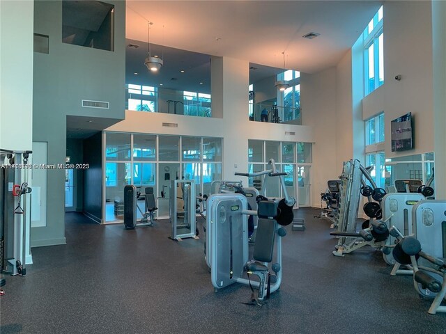 gym with a towering ceiling