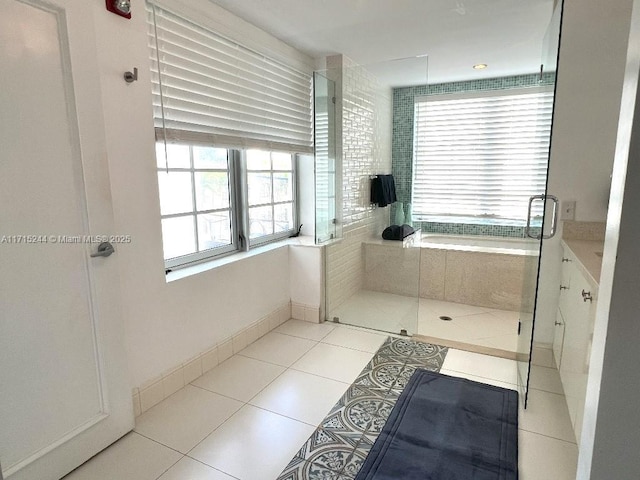 bathroom featuring tile patterned floors, vanity, and independent shower and bath