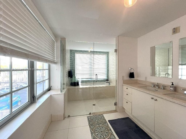 bathroom featuring tile patterned flooring, vanity, and shower with separate bathtub