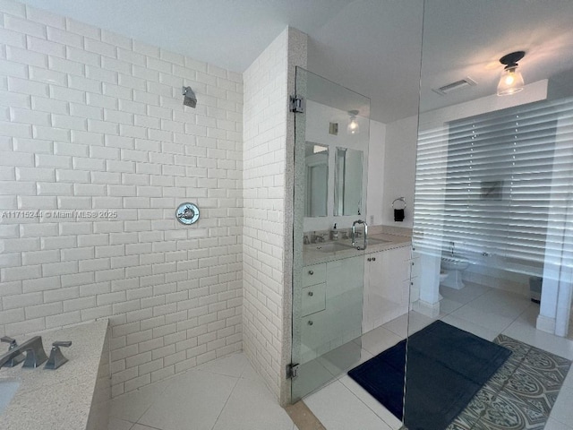 bathroom with tile patterned floors, vanity, and a shower