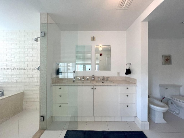 bathroom with tile patterned flooring, toilet, a shower with shower door, and a bidet