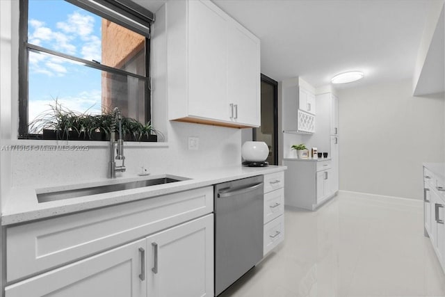 kitchen featuring dishwasher, white cabinets, light stone countertops, and sink