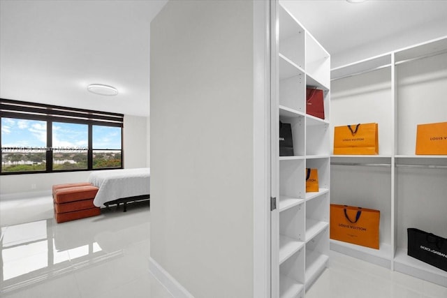 spacious closet featuring light tile patterned floors