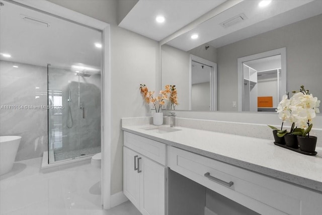 bathroom with tile patterned floors, a shower with door, vanity, and toilet