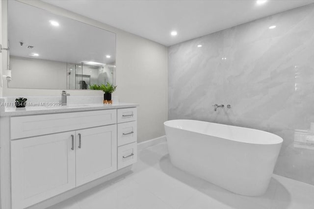 bathroom with vanity and a tub