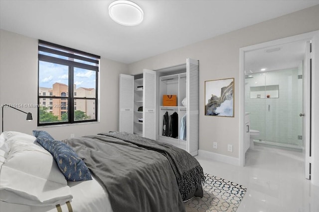 tiled bedroom with ensuite bathroom and a closet