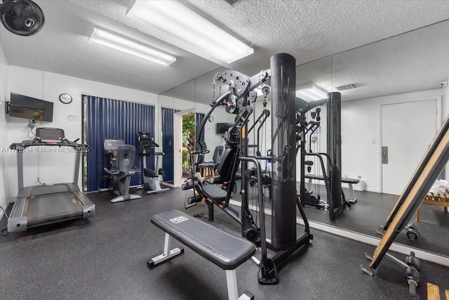 exercise room featuring a textured ceiling